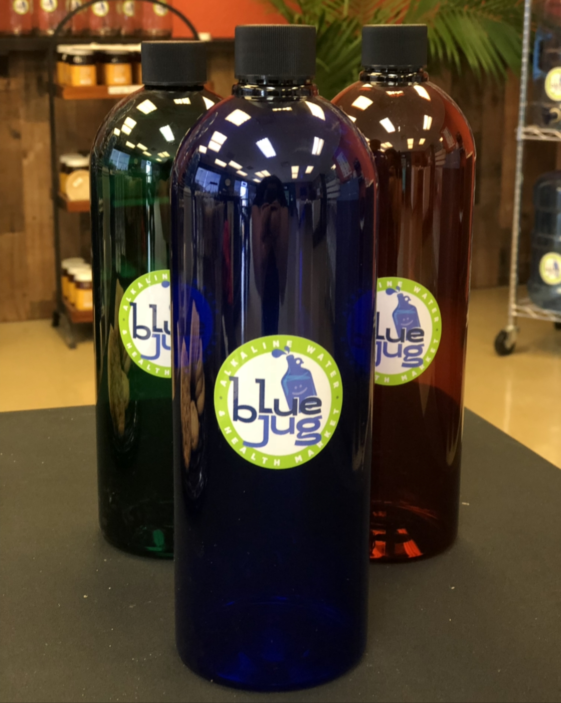 Three Blue Jug Bottles featuring the Blue Jug Logo