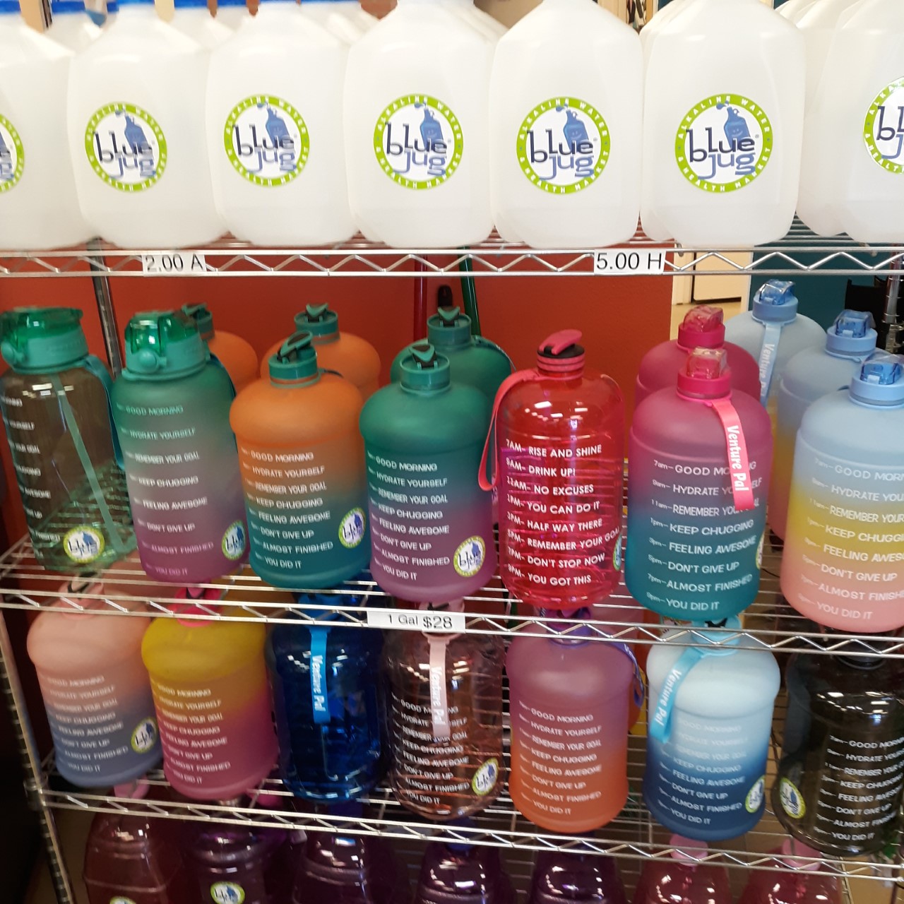Assorted gallon drink bottles displayed on a stand